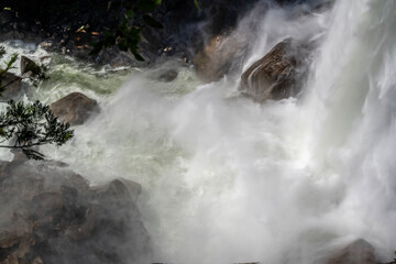 Fototapeta na wymiar Crashing waters and rainbows of Yosemite National Park's Vernal Falls