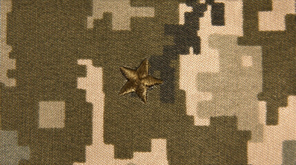 Army shoulder strap with an embroidered star against the background of camouflage. Military patch....