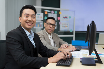 Asian, business man and office. Two Asian business men wearing suite working and meeting together in the office
