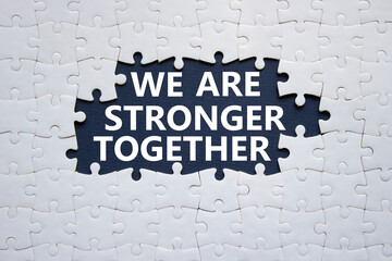 We are stronger together symbol. White puzzle with words We are stronger together. Beautiful black...