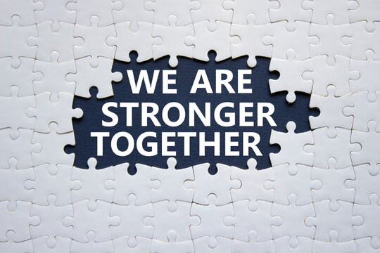 We are stronger together symbol. White puzzle with words We are stronger together. Beautiful black background. We are stronger together concept. Copy space.