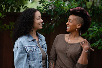 A recently engaged lesbian couple cannot stop laughing and smiling as they pose for romantic photos...