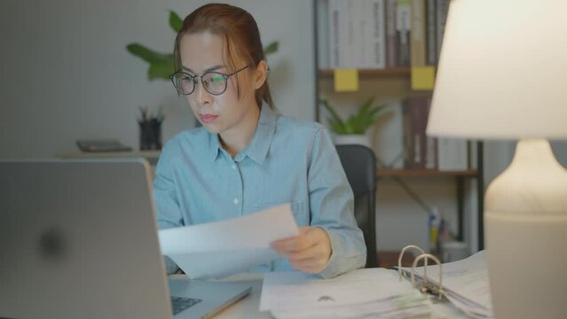 businesswoman asia busy late night working on desk laptop computer in chronic suffer burnout brownout office syndrome anxiety workforce at home.&nbsp;