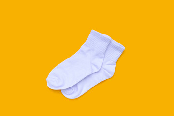 White socks on yellow background.