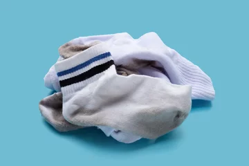 Foto op Canvas Dirty white socks on blue background. © Bowonpat