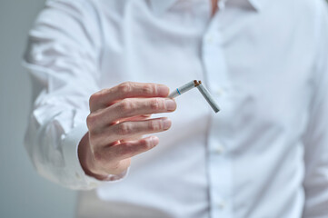 Middle-aged man struggling to quit smoking, smoking