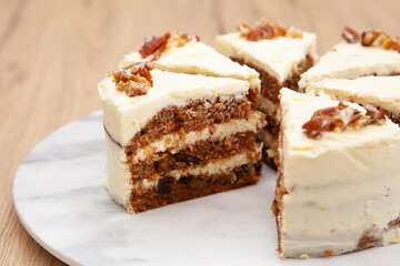 Classic carrot cake with cream cheese frosting, pecan, walnut and raisin