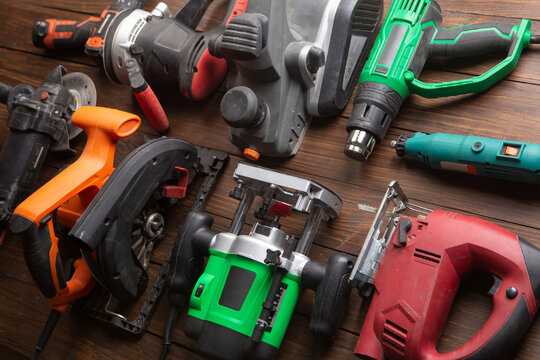 Set of electric tools on the wooden table. Various power tools for renovation and construction