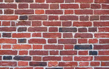 Obraz premium Texture of an old and damaged red brick wall as an architectural background