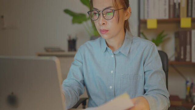 businesswoman asia busy late night working on desk laptop computer in chronic suffer burnout brownout office syndrome anxiety workforce at home.&nbsp;
