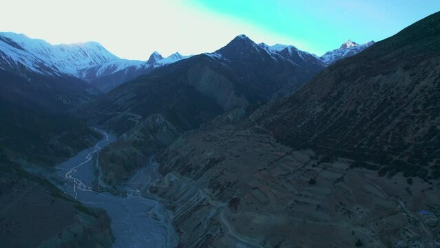 Aerial birds eye view valley with river stream and Tanki village houses in Mamang district. Tilicho base camp trail. Himalayas mountains and trekking concept.