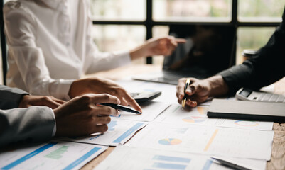 Business people meeting at office writing notes about sticky notes Laptop,tablet  Planning and Brainstorming Strategies of Colleagues in office.