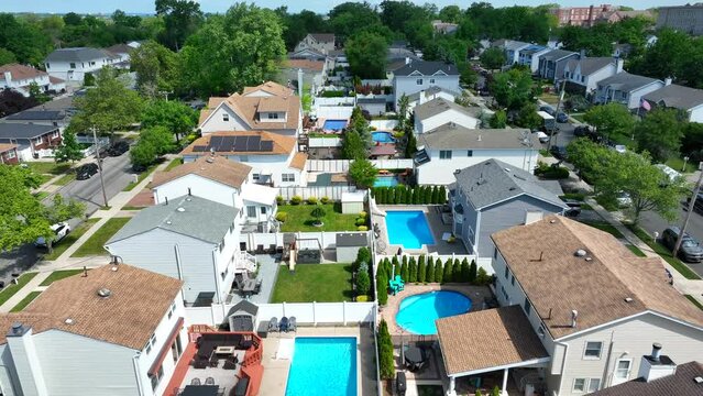 Slow birds eye flight over luxury neighborhood in america with private swimming pools - Staten Island, New York City