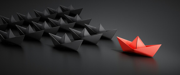 Group of black paper boats with red leader on dark background	