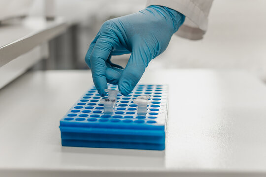 Hand of scientist holding dna test tube in laboratory