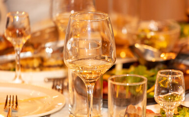Glasses of white wine on the table ready for a romantic dinner