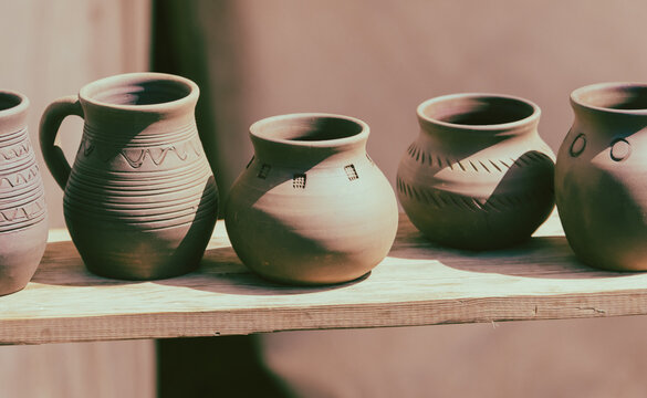 clay pots on the shelf in the store, closeup of photo