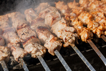 Cooking meat skewers on skewers on the grill