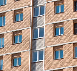 Fototapeta na wymiar Windows and walls in a multi-storey building. Background