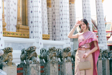 Beautiful Asian girl in Thai traditional costume at temple