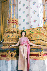 Beautiful Asian girl in Thai traditional costume at temple