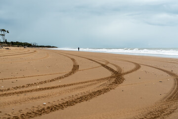 Tyre tracks on the sand, in the morning, at Moore Park Beach Queensland, Australia
