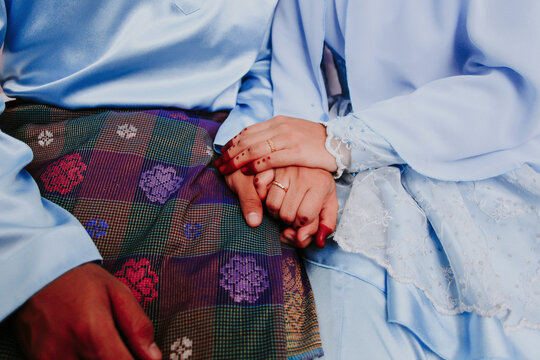 Newly wedding Muslim couple hand holding. Selective focus.