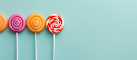 Photo of a colorful stack of lollipops perfect for sweet treats and festive celebrations with copy space