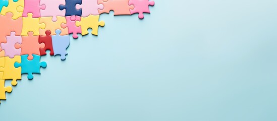 Photo of colorful puzzle pieces on a vibrant blue background with plenty of copy space with copy space