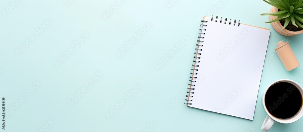 Poster photo of a coffee cup, notepad, and plant on a table with plenty of space for your own message with 