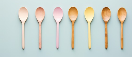 Photo of six spoons arranged in a neat row on a vibrant blue background with copy space