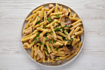 Homemade One-Pot Creamy Chicken Marsala Pasta with Parsley on a Plate, top view. Flat lay, overhead, from above.