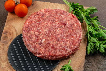 Raw Ground beef meat Burger steak cutlets on a wooden board, Food recipe background. Close up