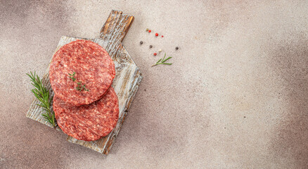 Minced beef patties on a wooden board, Ingredients for cooking burgers, Long banner format. top view
