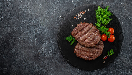 grilled hamburger patties on a dark background, Long banner format. top view