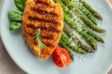 juicy chicken breast grilled with vegetables asparagus and parmesan, organic healthy products. Detox and clean diet concept. place for text, top view