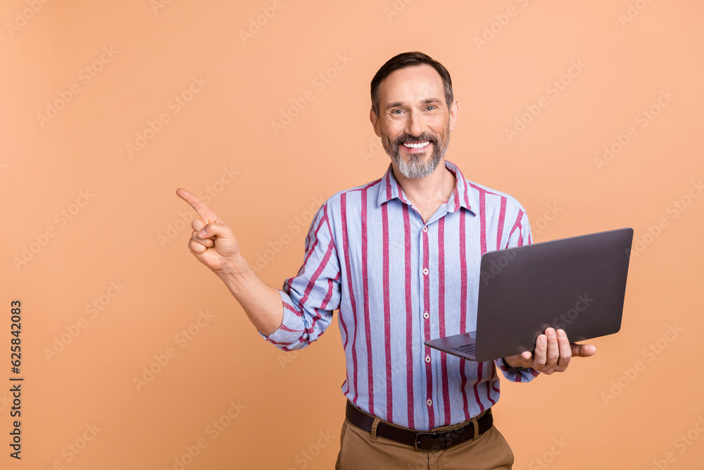 Sticker portrait of handsome successful person hold wireless netbook indicate finger empty space isolated on