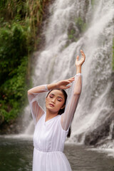 Young Girl in White Shirt poses near Jagir Waterfall in Banyuwangi