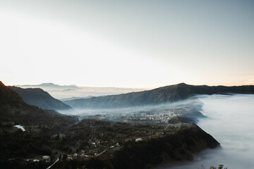 Cemoro Lawang village near Gunung Bromo or Mount Bromo is covered by clouds at dawn viewed from Seruni Sunrise Point