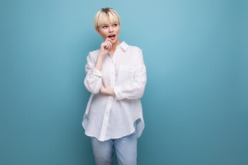 young charming pleasant pretty caucasian office worker woman with short blond hair is dressed in a white blouse on a background with copy space. business concept