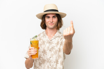Young handsome man holding a cocktail isolated on white background doing coming gesture