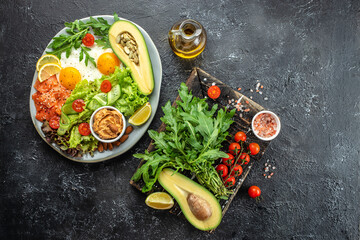 Healthy eating food vegetables salad, avocado, fish, eggs, nuts peanut paste. low carb keto...