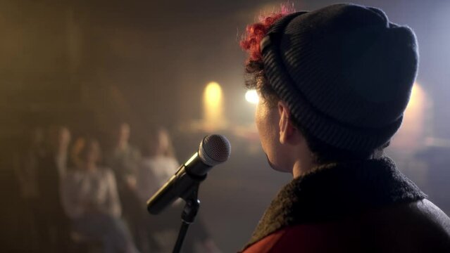The performance of the guy in front of a small hall of people. An independent speaker speaks on stage in a conference room for young people. A man explains motivation to a group of people. Team meetin