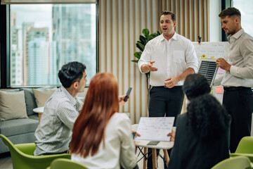 In diverse workspace, project manager presents eco-friendly solar panels, and sustainable solutions