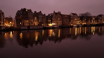 Pink and purple dawn light over the canal houses in Amsterdam