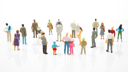 miniature people. different people stand on a white background. people communicate with each other....