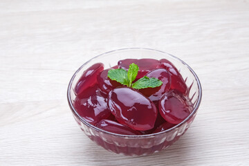 Manisan Kolang-Kaling, or preserved sugar palm fruit with purple color, Indonesian drink and dessert during the month of Ramadan. Selected focus.
