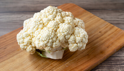 single piece of cauliflower on the wooden board