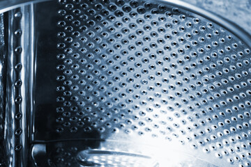 Used washing machine drum made of stainless steel, abstract photo