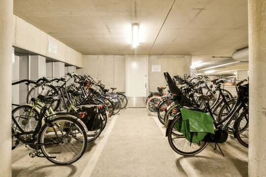 several bikes parked in a parking space with no one on the ground, and there is an open area for them to use